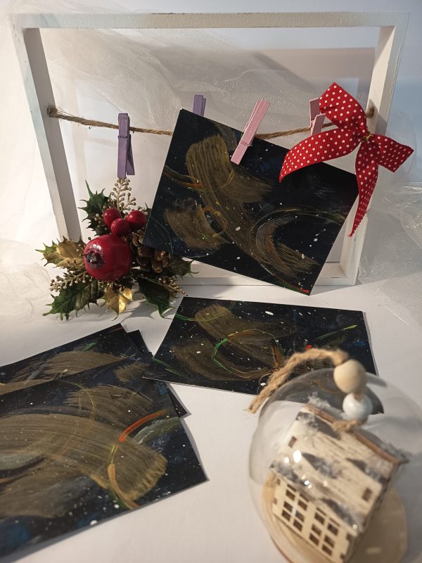 Carte de noël artisanale – Cosmos — fond noir, touches dorées et argentées, effet céleste